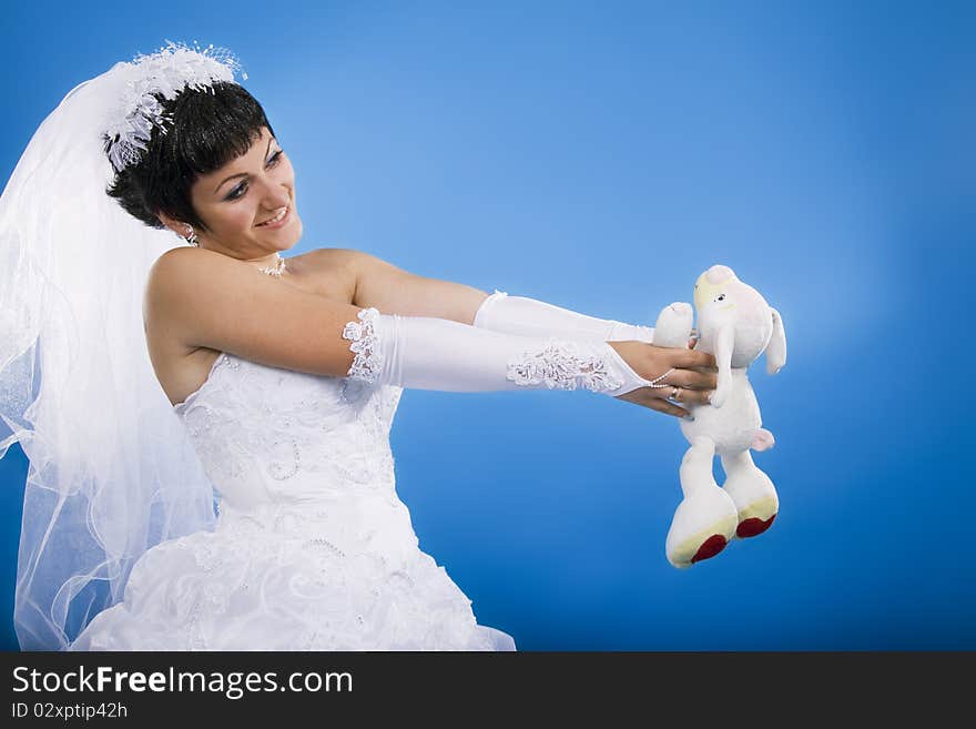 One happy and Beautiful bride on blue background. One happy and Beautiful bride on blue background.