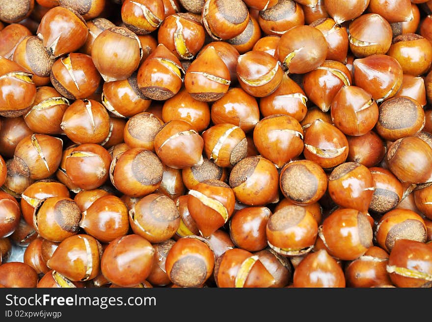 Sweet crisp fried chestnuts in a wok in a Chinese local market.