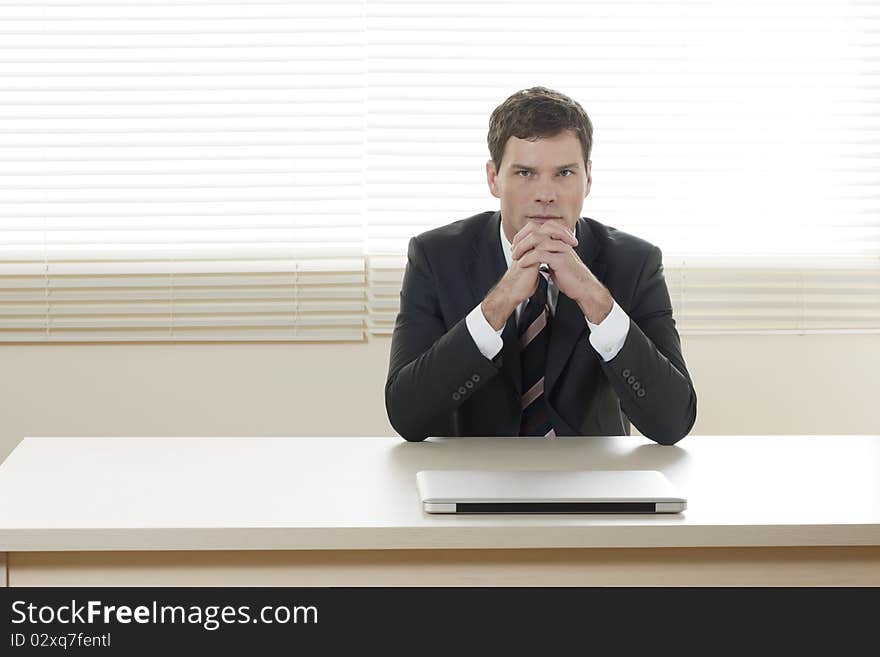 Portrait of a successful businessman at his desk