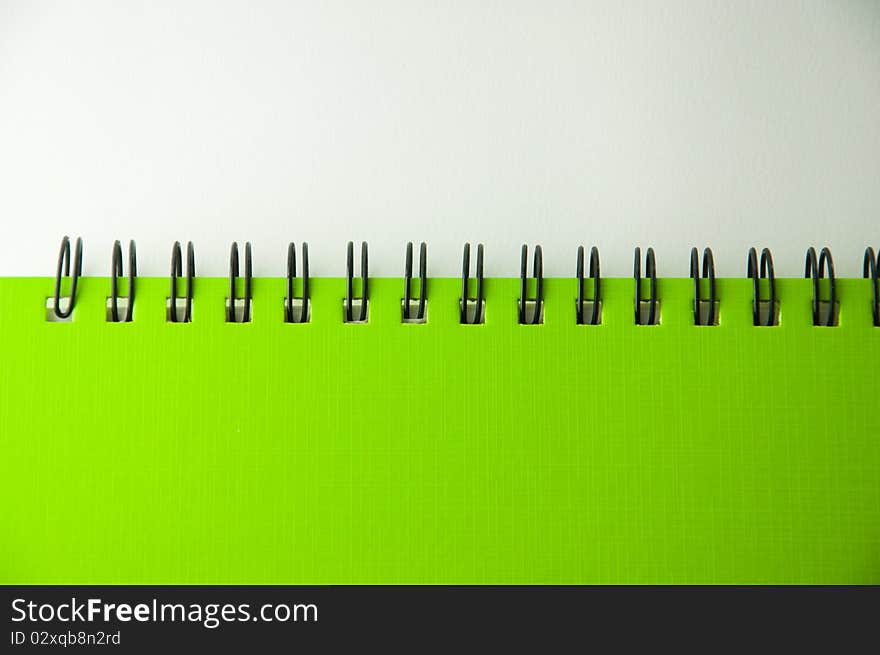 Isolated green notebook on white.