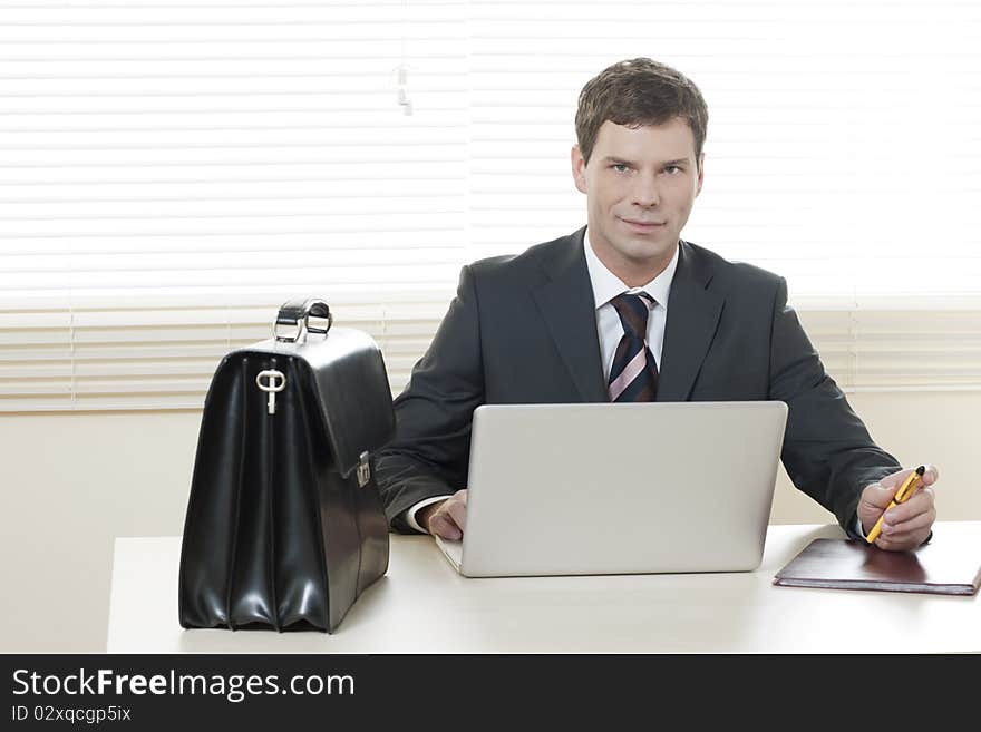 Businessman working on laptop in his office