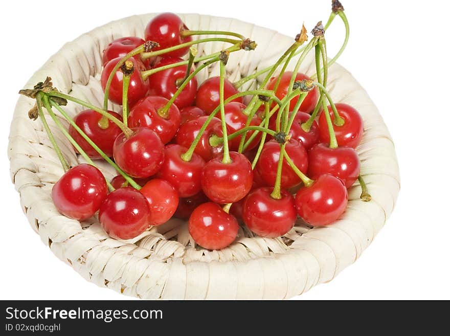 Cherries in a wicker basket isolated on a white background