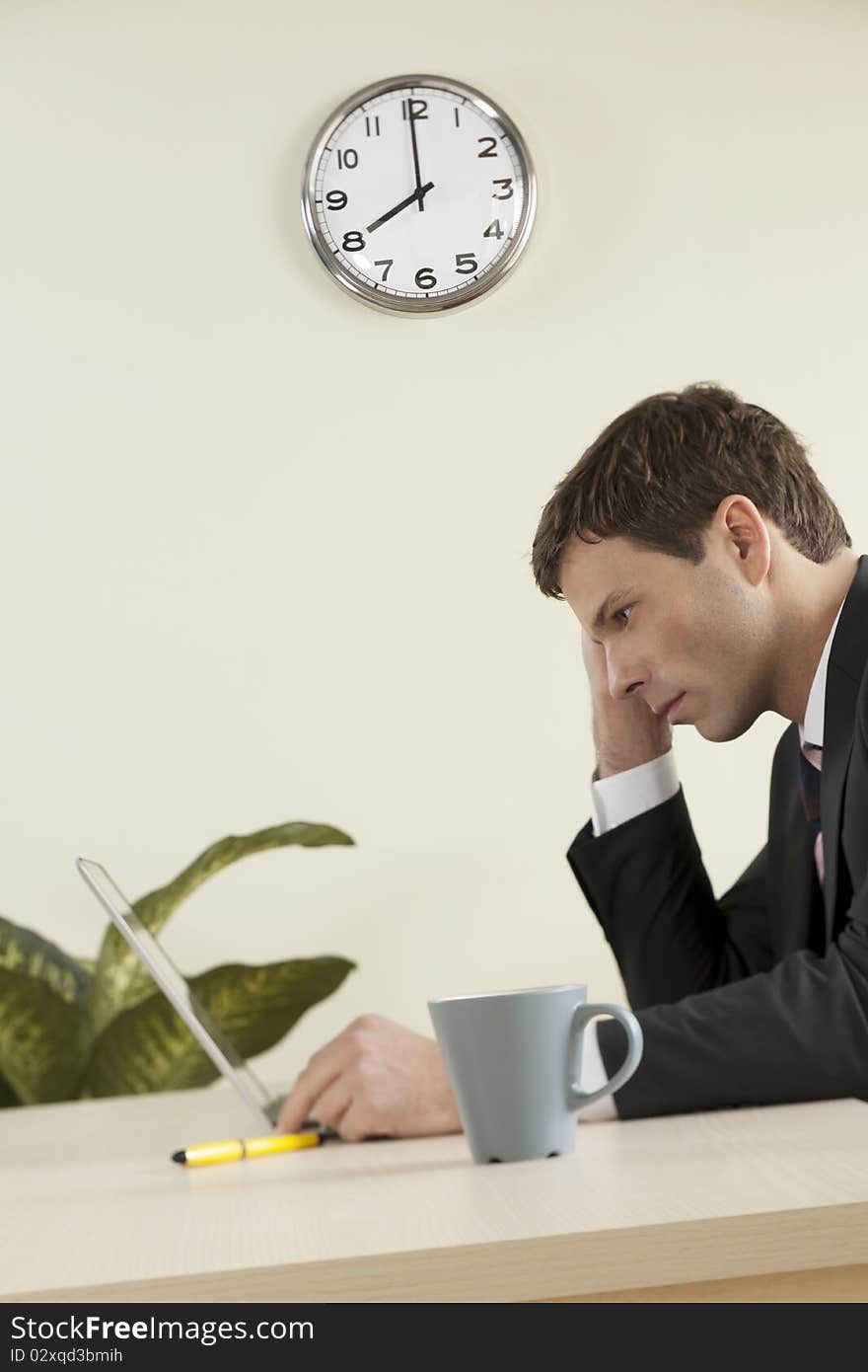 Businessman working on laptop in the office