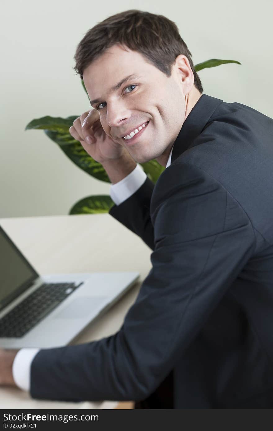 Businessman working on laptop in his office