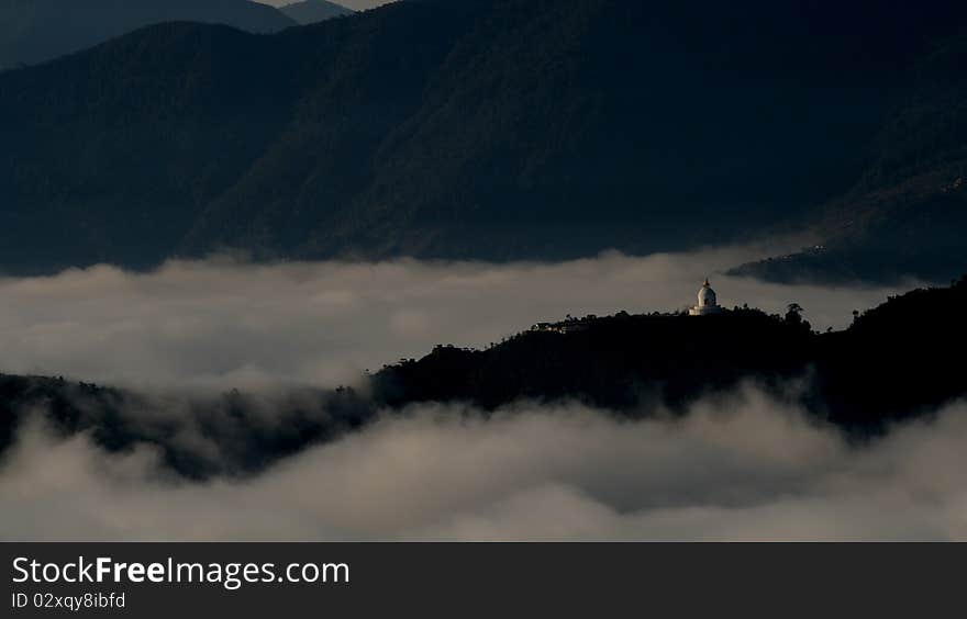 A buddhist temple in a mountain above cloud in Nepal