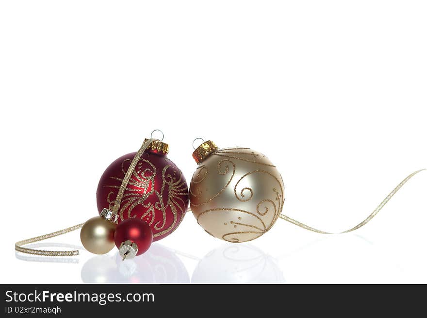 Red and Gold Baubles with reflection isolated on white