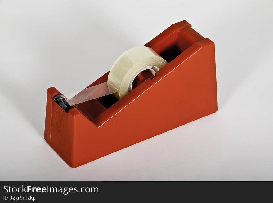 This image shows a Adhesive tape with its support with a white background