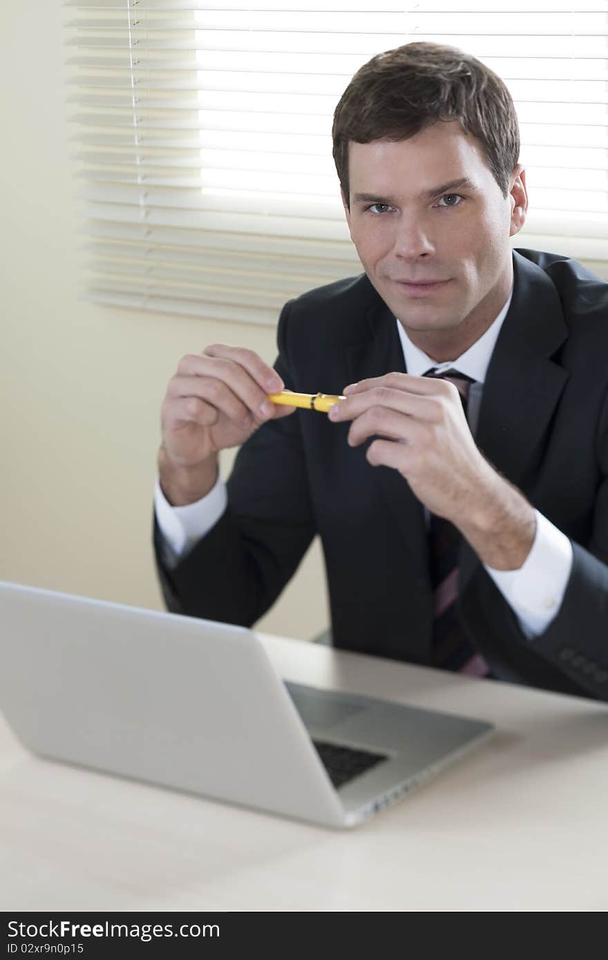 Businessman working on laptop in his office