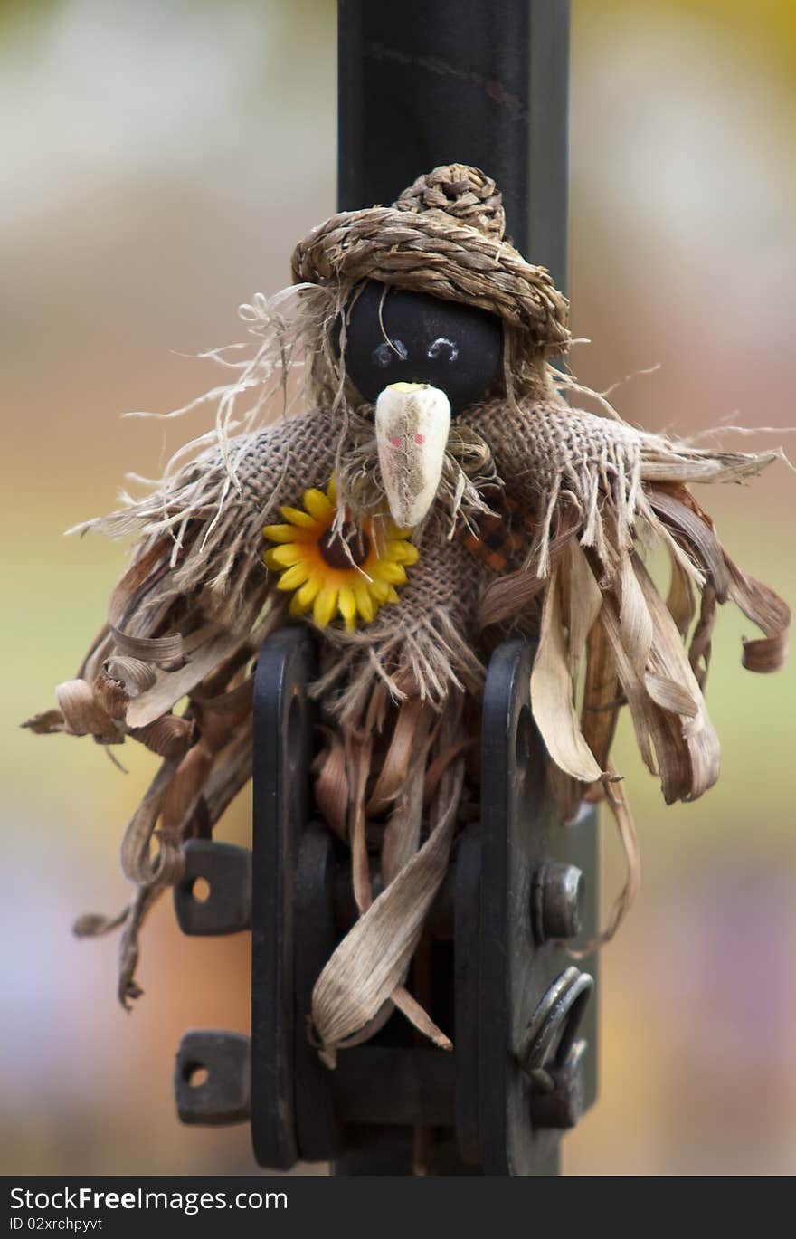 A miniature scarecrow hung up for Halloween. A miniature scarecrow hung up for Halloween