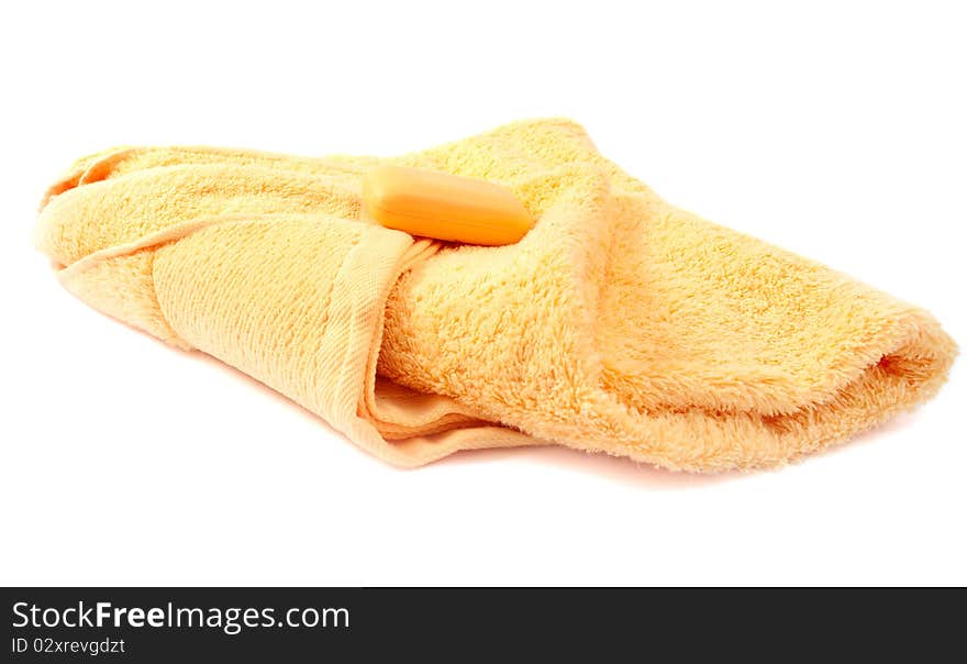 Yellow towel and soap on a white background