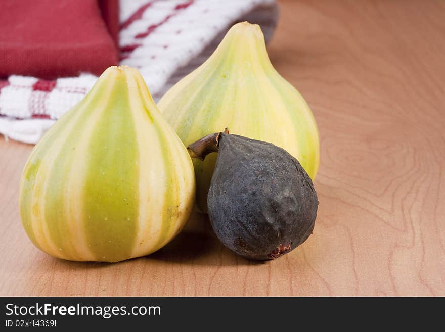 Ripe fruits of a fig on a wooden table.