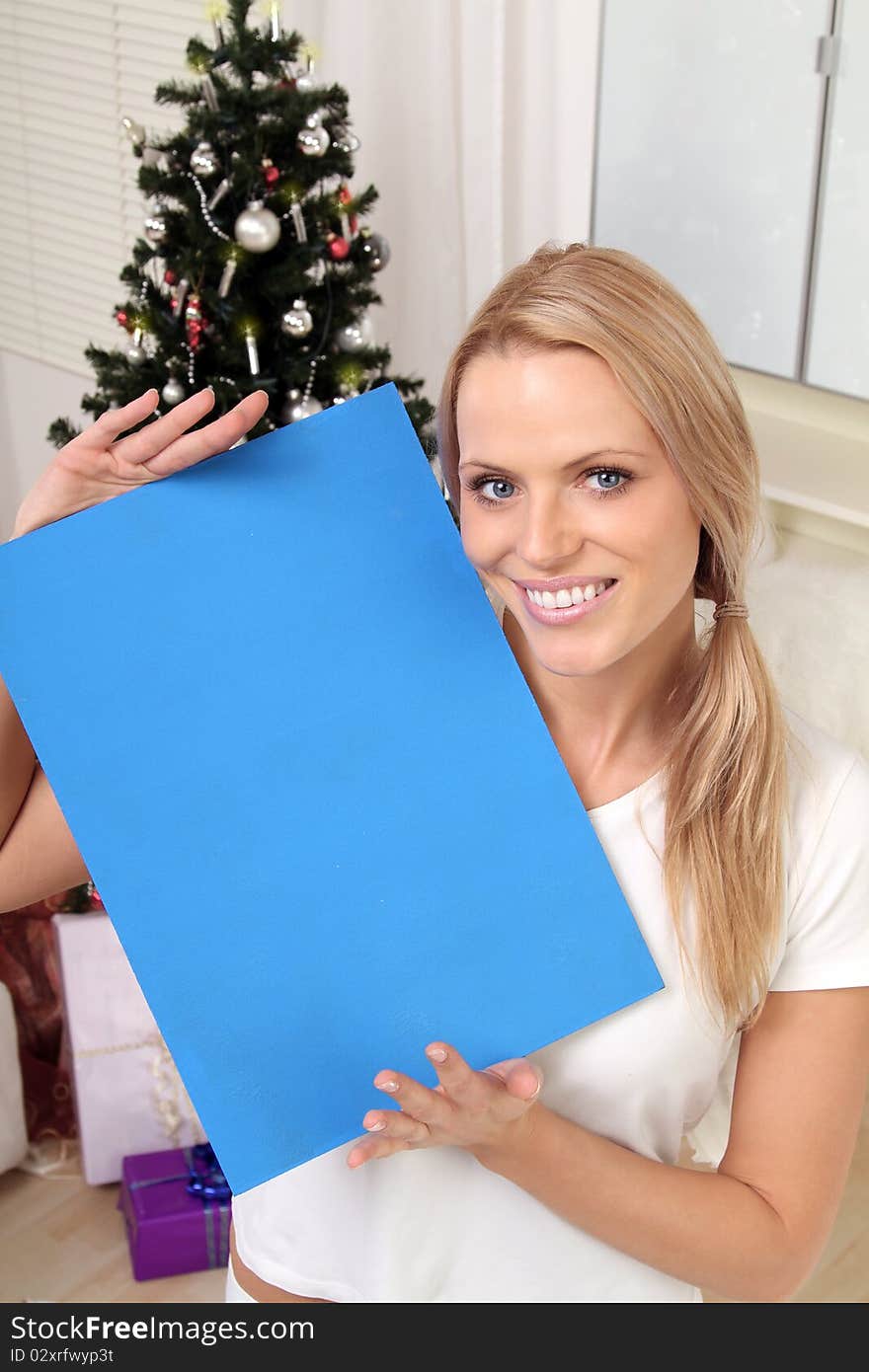 Beautiful blond christmas-angel holding a sign. Beautiful blond christmas-angel holding a sign