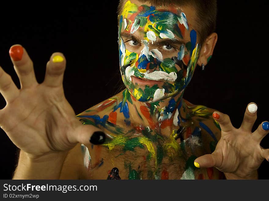 Young guy face, body and hands painted with colored ink. Young guy face, body and hands painted with colored ink