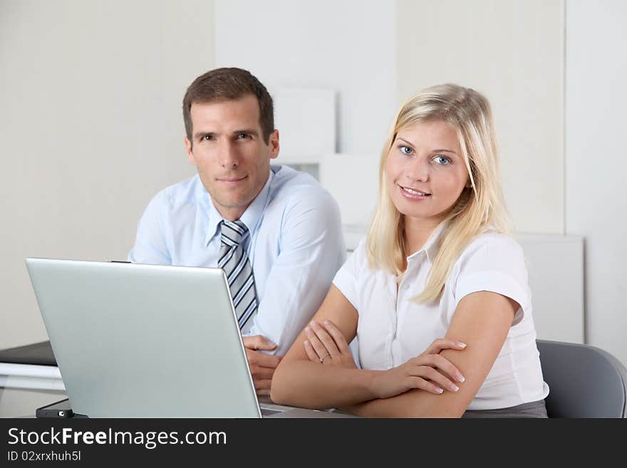 Man and woman working in the office on laptop computer. Man and woman working in the office on laptop computer