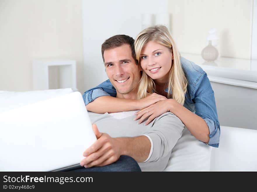 Closeup of couple sitting in sofa surfing on internet. Closeup of couple sitting in sofa surfing on internet