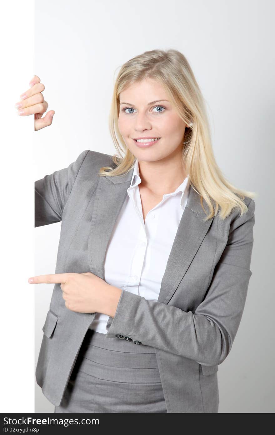 Smiling businesswoman holding white panel. Smiling businesswoman holding white panel