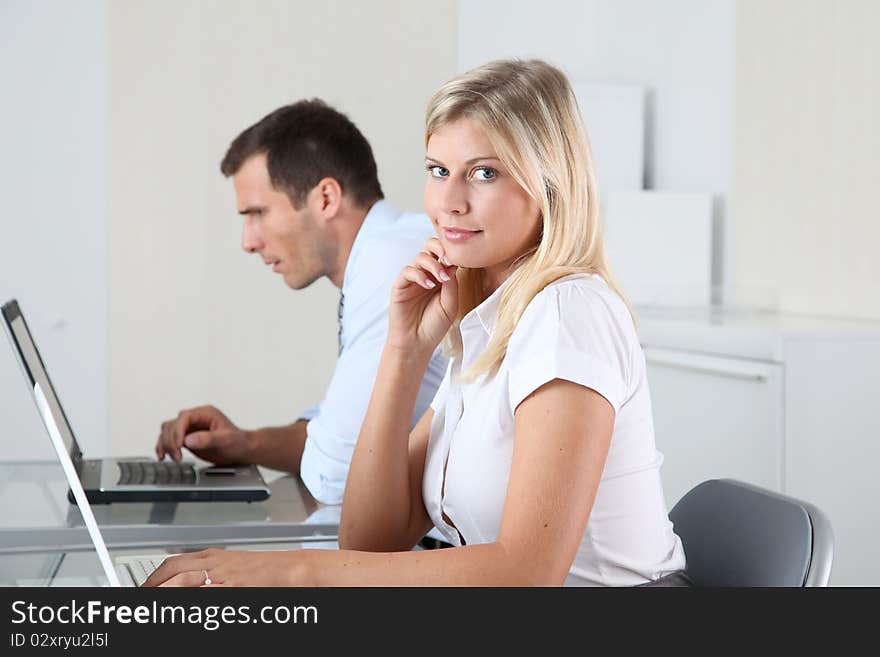 Man and woman working in the office on laptop computer. Man and woman working in the office on laptop computer