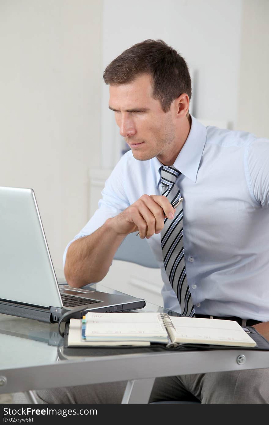 Man working in the office with laptop computer. Man working in the office with laptop computer