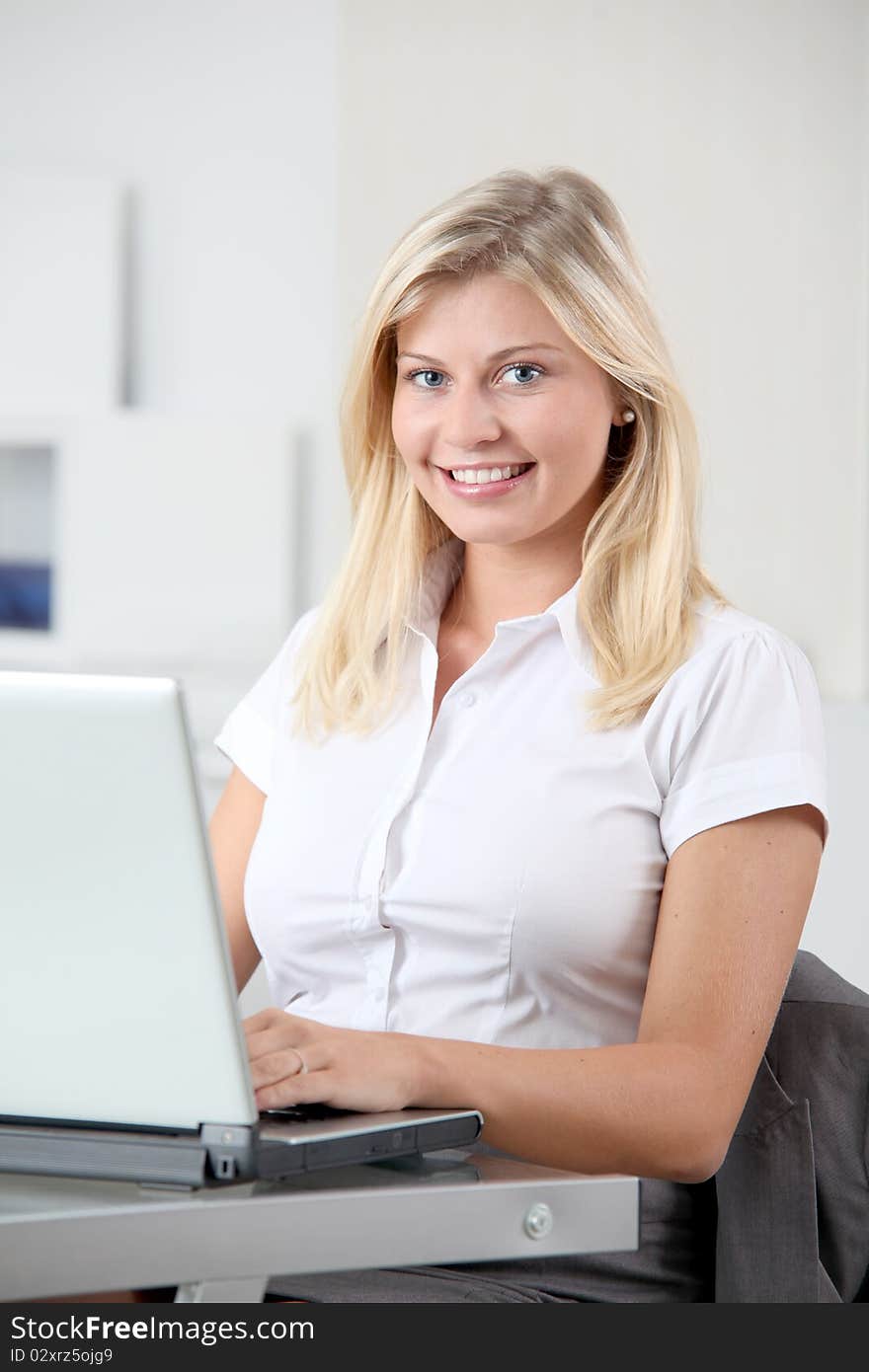 Beautiful smiling young woman working in the office. Beautiful smiling young woman working in the office