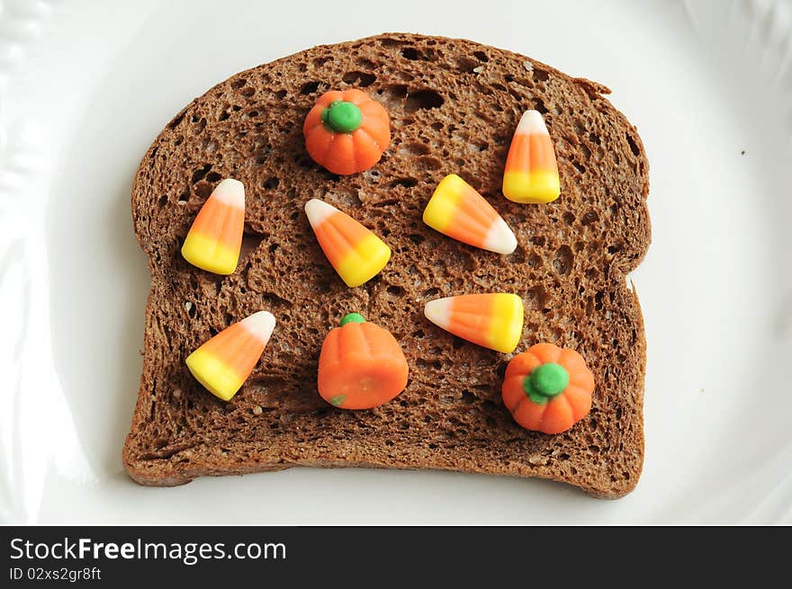 An unhealthy halloween snack. A candycorn and bread sandwich!