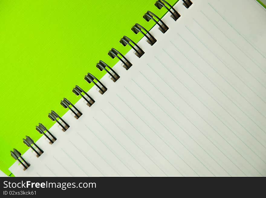 Isolated green notebook on white.