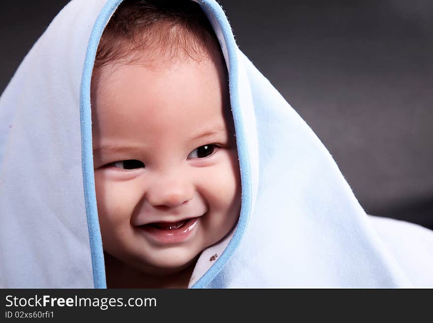 Baby Smiling with blanket on his head