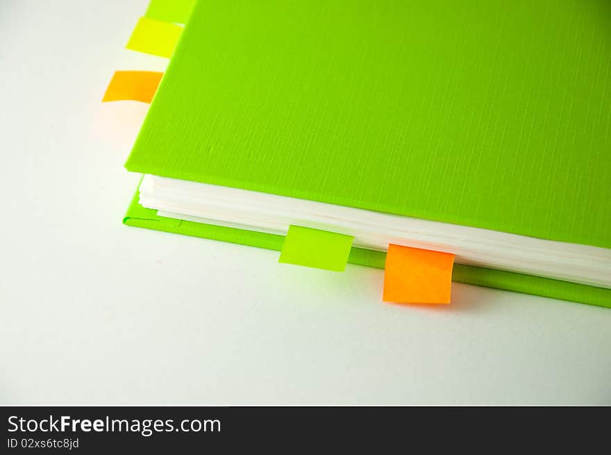 Isolated green notebook on white.