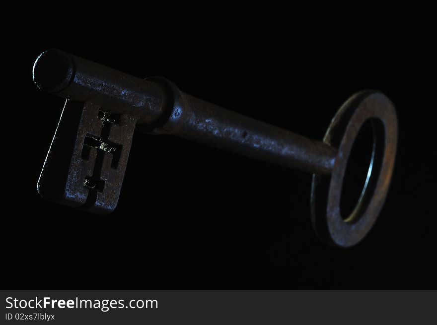 An Old Rusty Key On A Black Background. An Old Rusty Key On A Black Background.