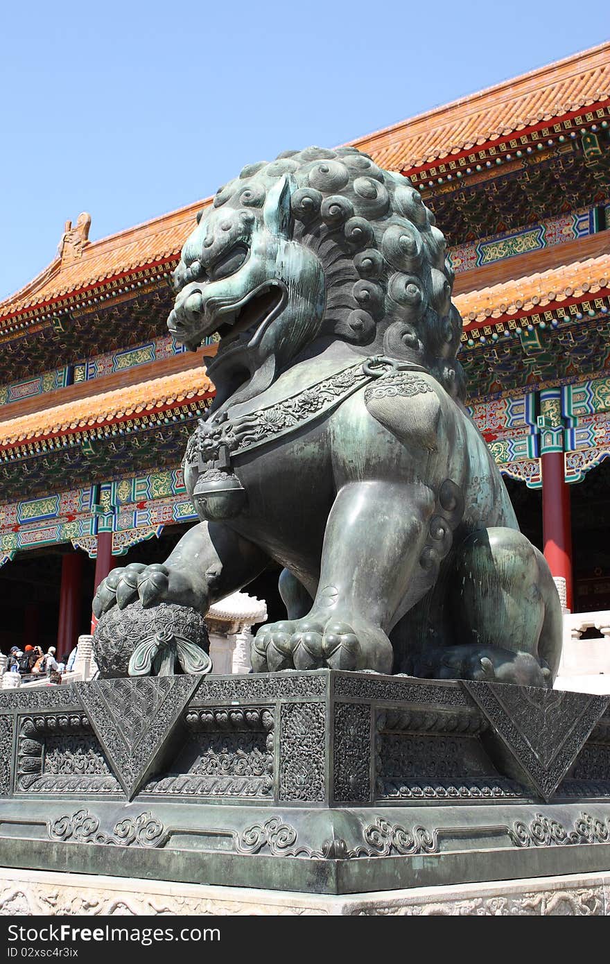 Lion Statue standing to protect the gates of the Forbidden City in Beijing, China.