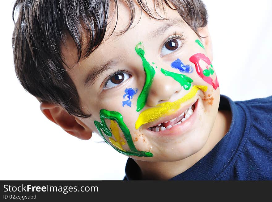 Messy cute kid with colors on his face, funny scene