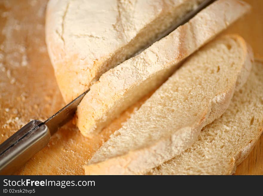 Knife and sliced bread on a cutting board