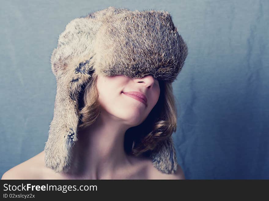 Fine art portrait of a woman in a fur winter cap. Fine art portrait of a woman in a fur winter cap