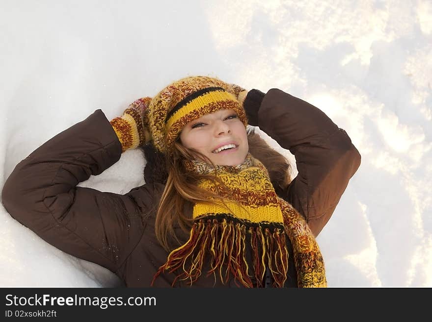 Cheerful girl in winter hat and mittens