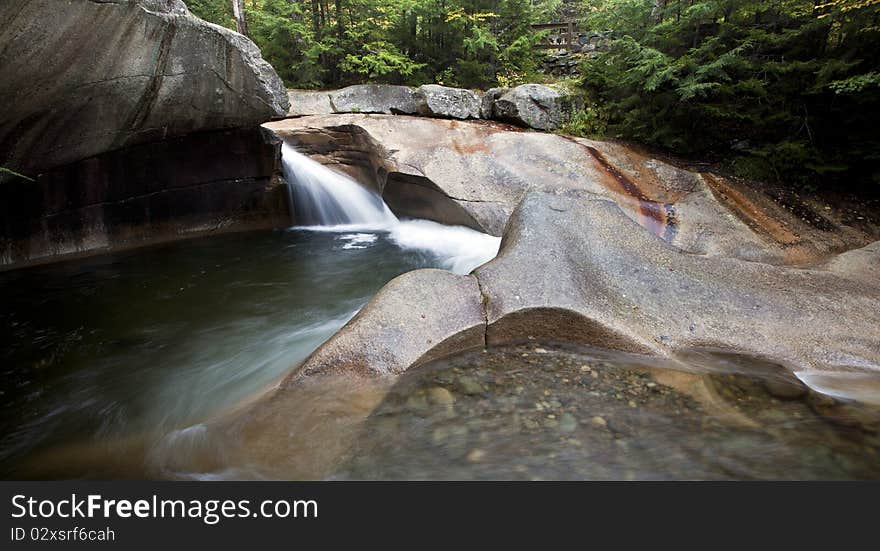 Waterfall at the basin in New Hampshire in early autumn