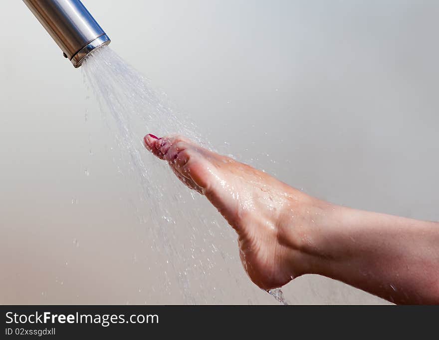 Detail of a girl's foot and water jet