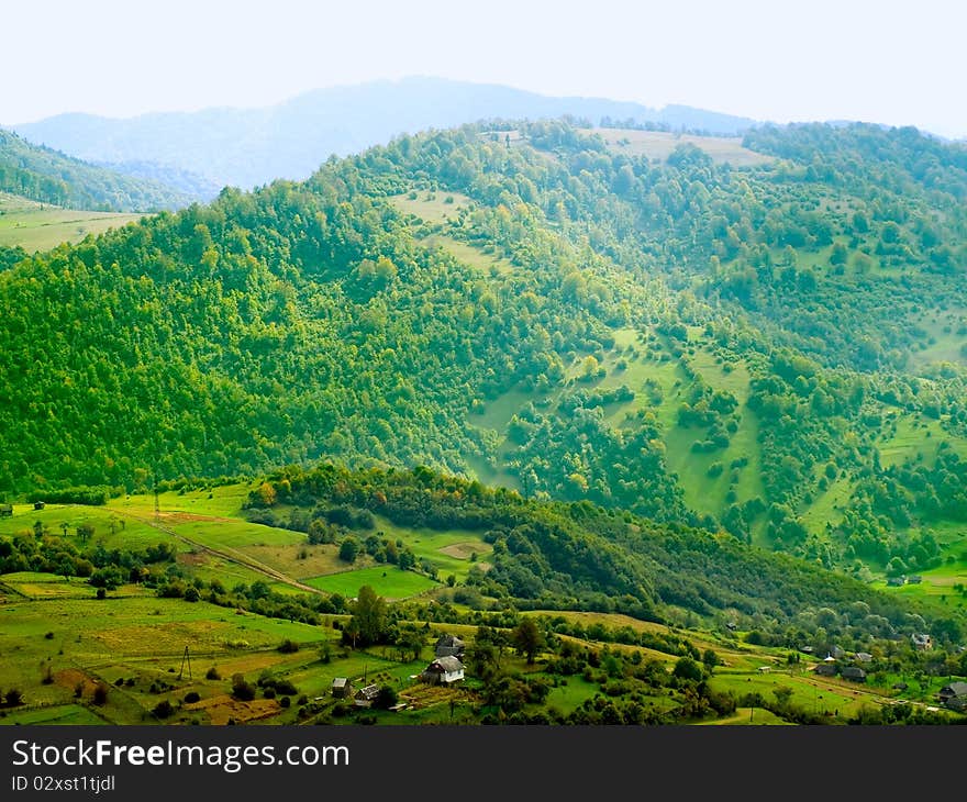 Ukrainian tranquil landscape with green meadow and blue mountains. Ukrainian tranquil landscape with green meadow and blue mountains.