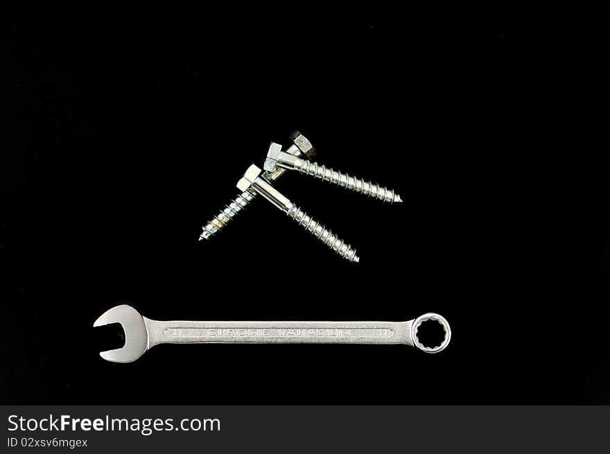 Ringpanner and screw on a black background. Ringpanner and screw on a black background