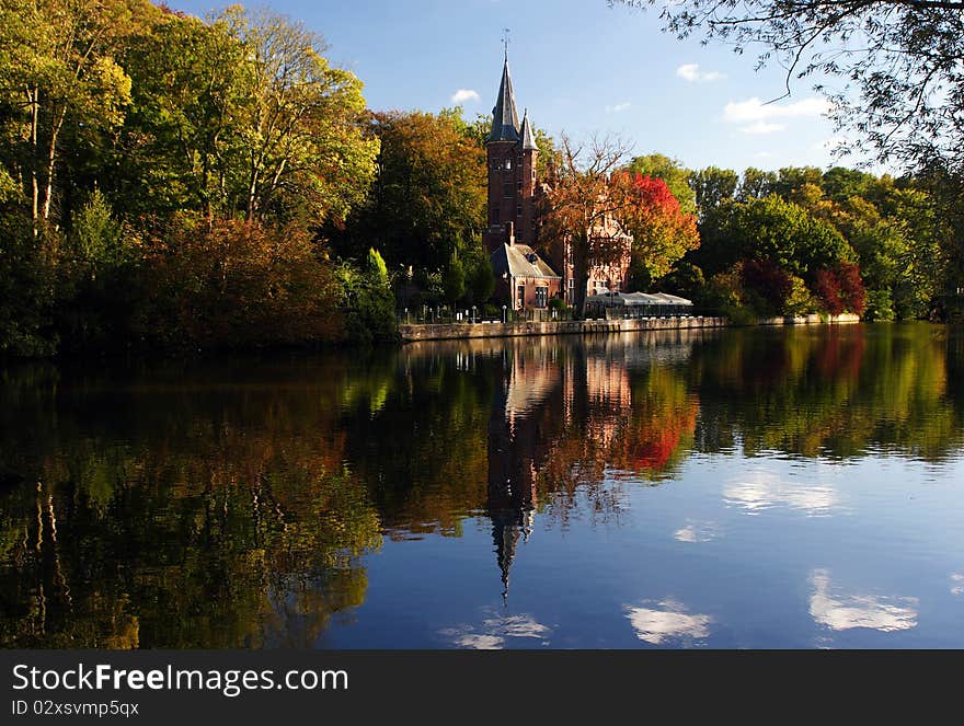 Castle and autumn trees mirrored on water. Castle and autumn trees mirrored on water