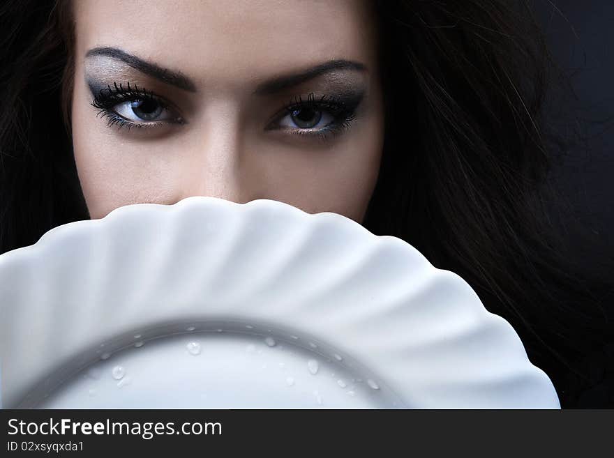 Glamour woman with a white porcelain plate