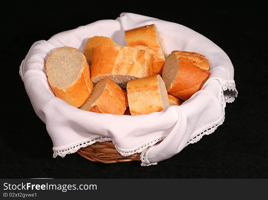 Picture of basket with bread pieces over a black background. Picture of basket with bread pieces over a black background