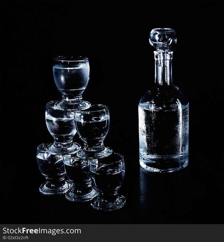 Studio shot of bottle and glasses over black