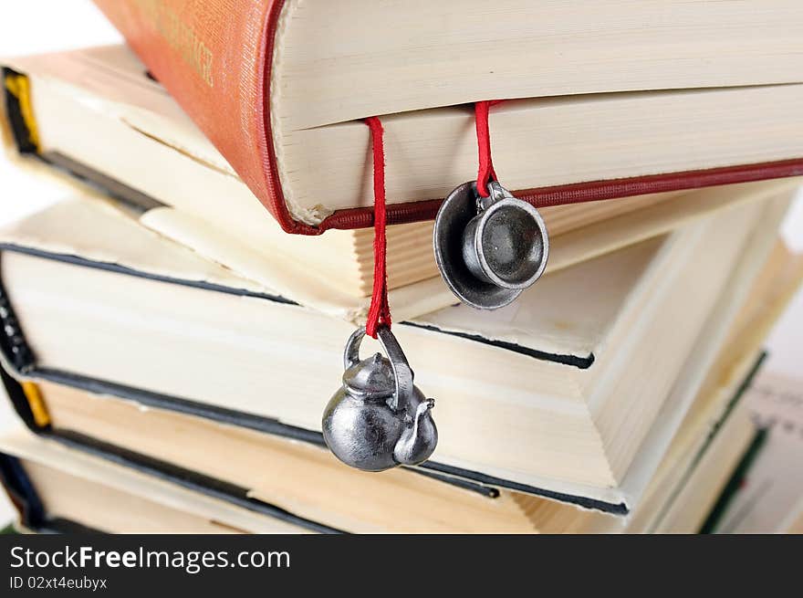 Stack of used books with a hand-made bookmark