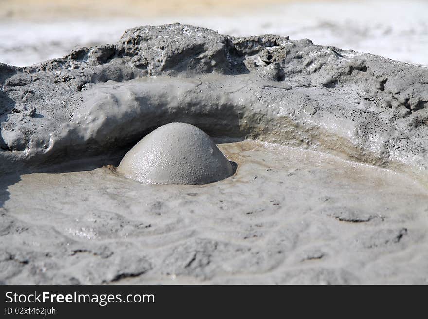 Mud Volcano in Buzau, Romania. The small volcano-shaped structures are caused by the eruption of mud and volcanic gases. Mud Volcano in Buzau, Romania. The small volcano-shaped structures are caused by the eruption of mud and volcanic gases.