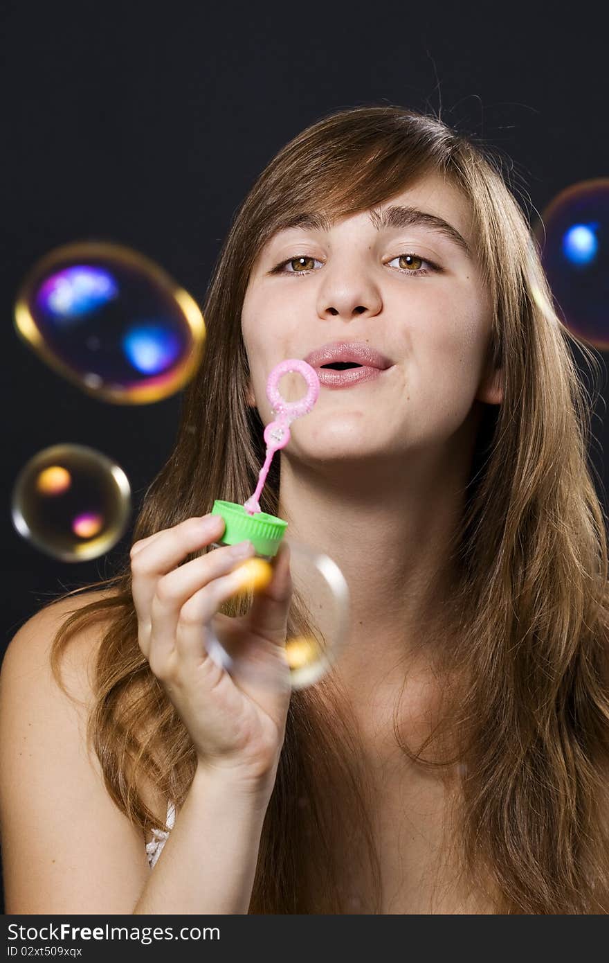 Young woman playing with bubbles. Young woman playing with bubbles