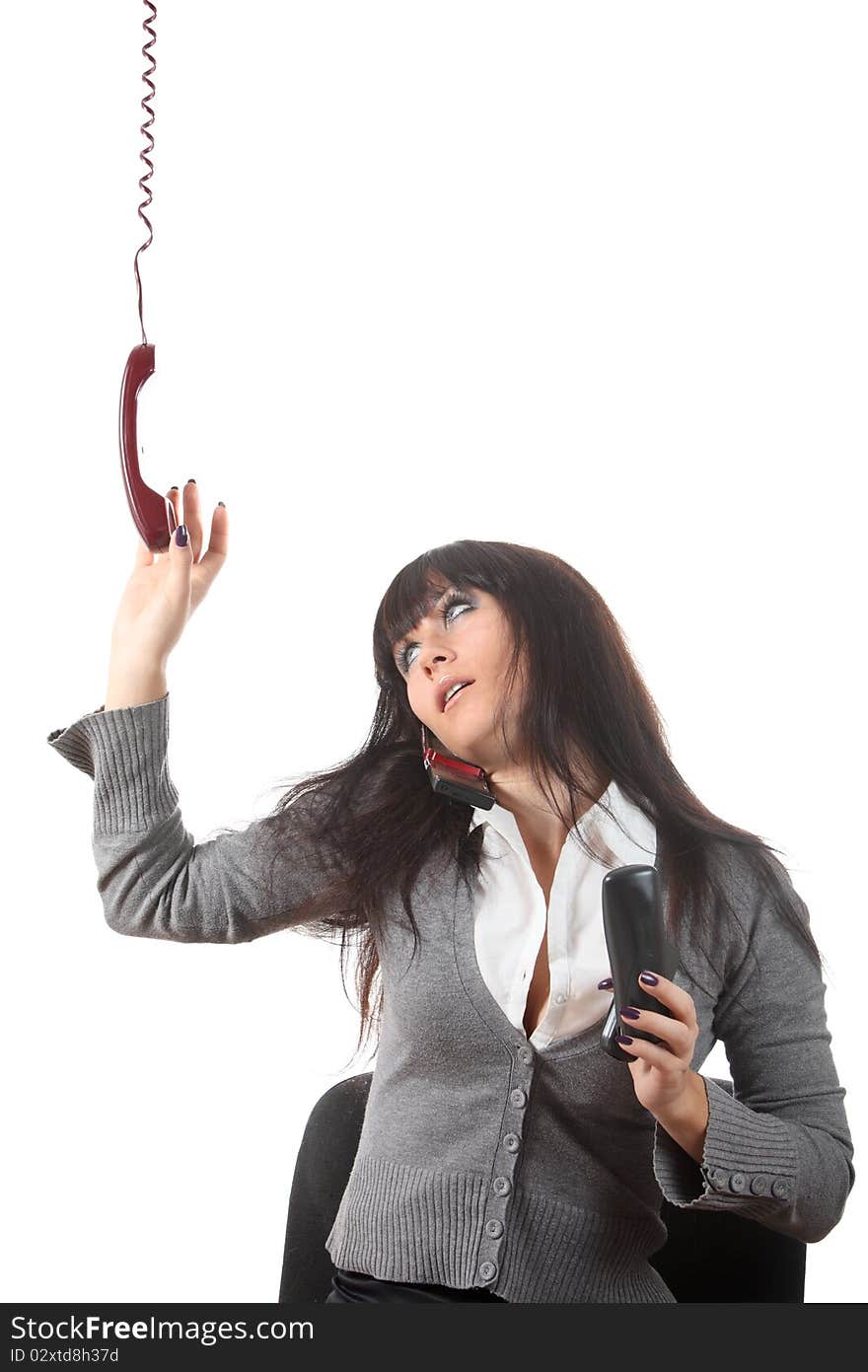 Businesswoman speak by four phones at the same time on her workspace