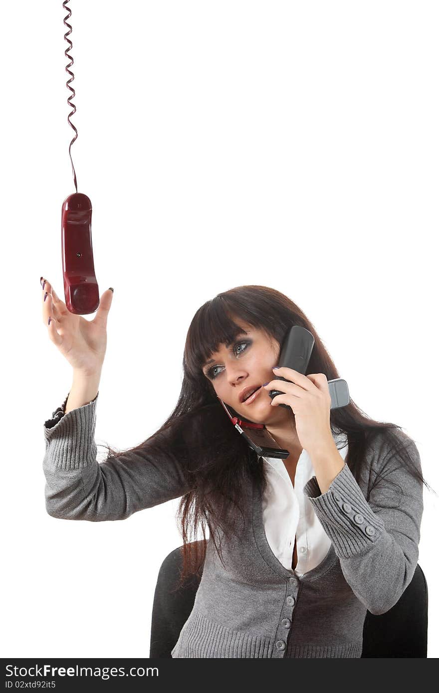 Businesswoman speak by four phones at the same time on her workspace