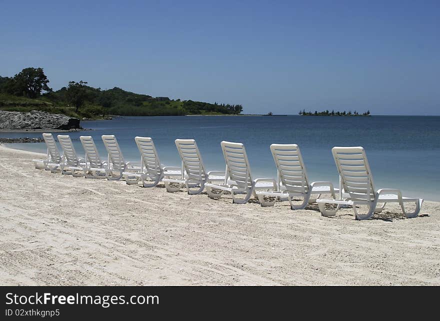 Row of chairs standing at the beach. Row of chairs standing at the beach