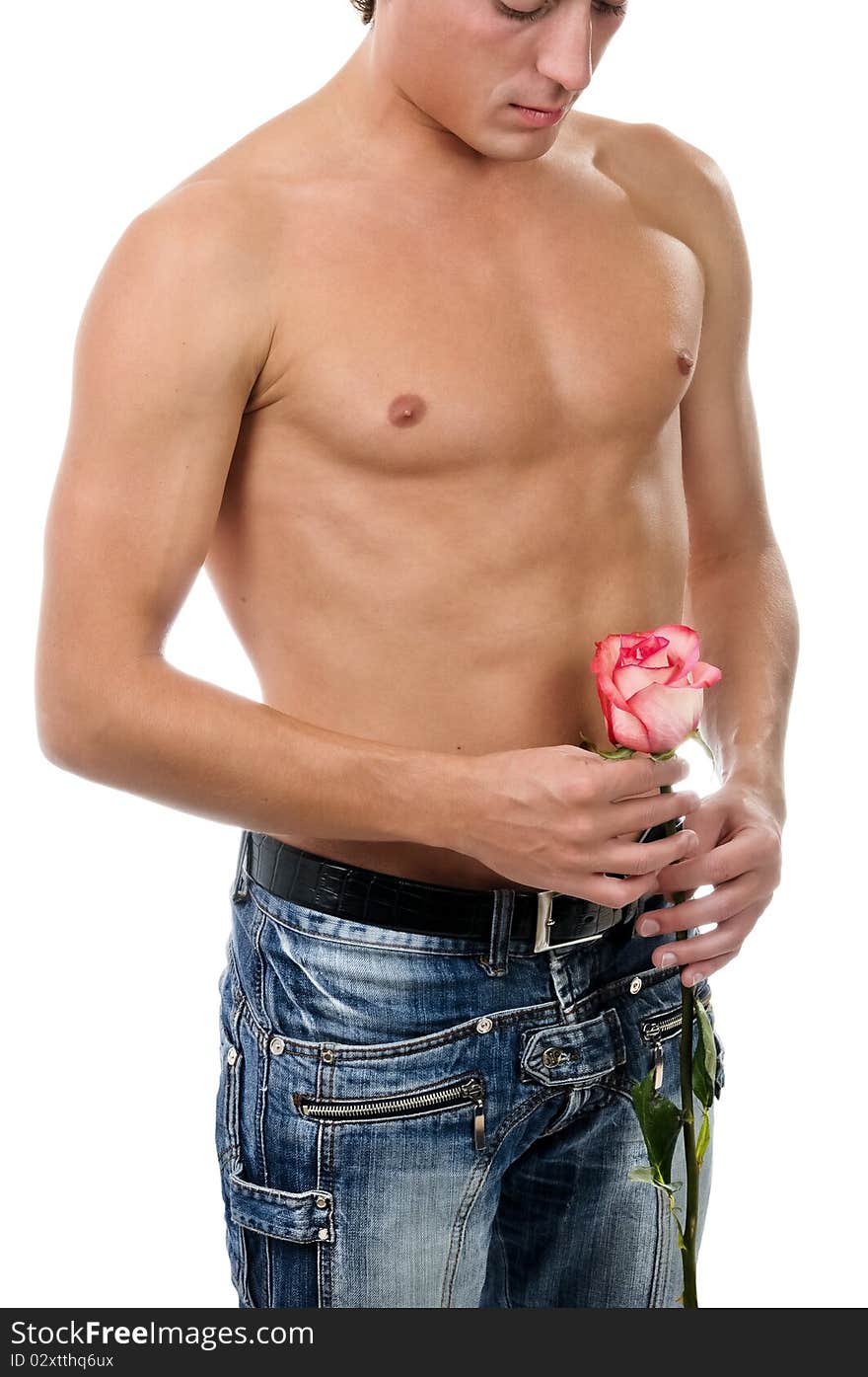 A fragment of man body in blue jeans and red rose. A fragment of man body in blue jeans and red rose