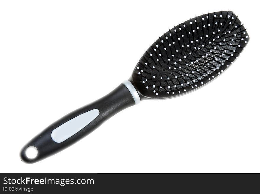 Black massage plastic comb on white background