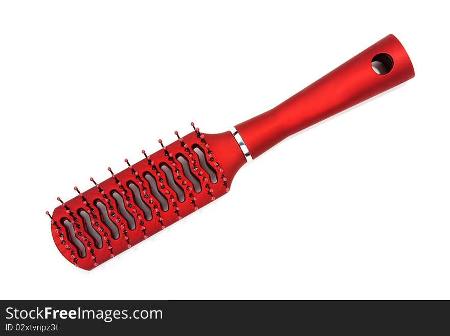 Red massage plastic comb on white background